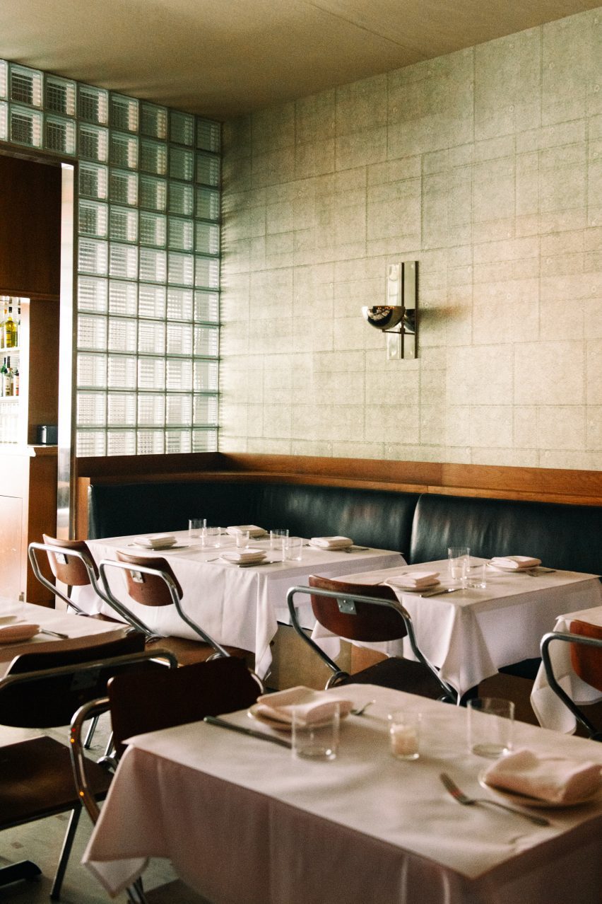 Restaurant with white tablecloths and glass block partitions