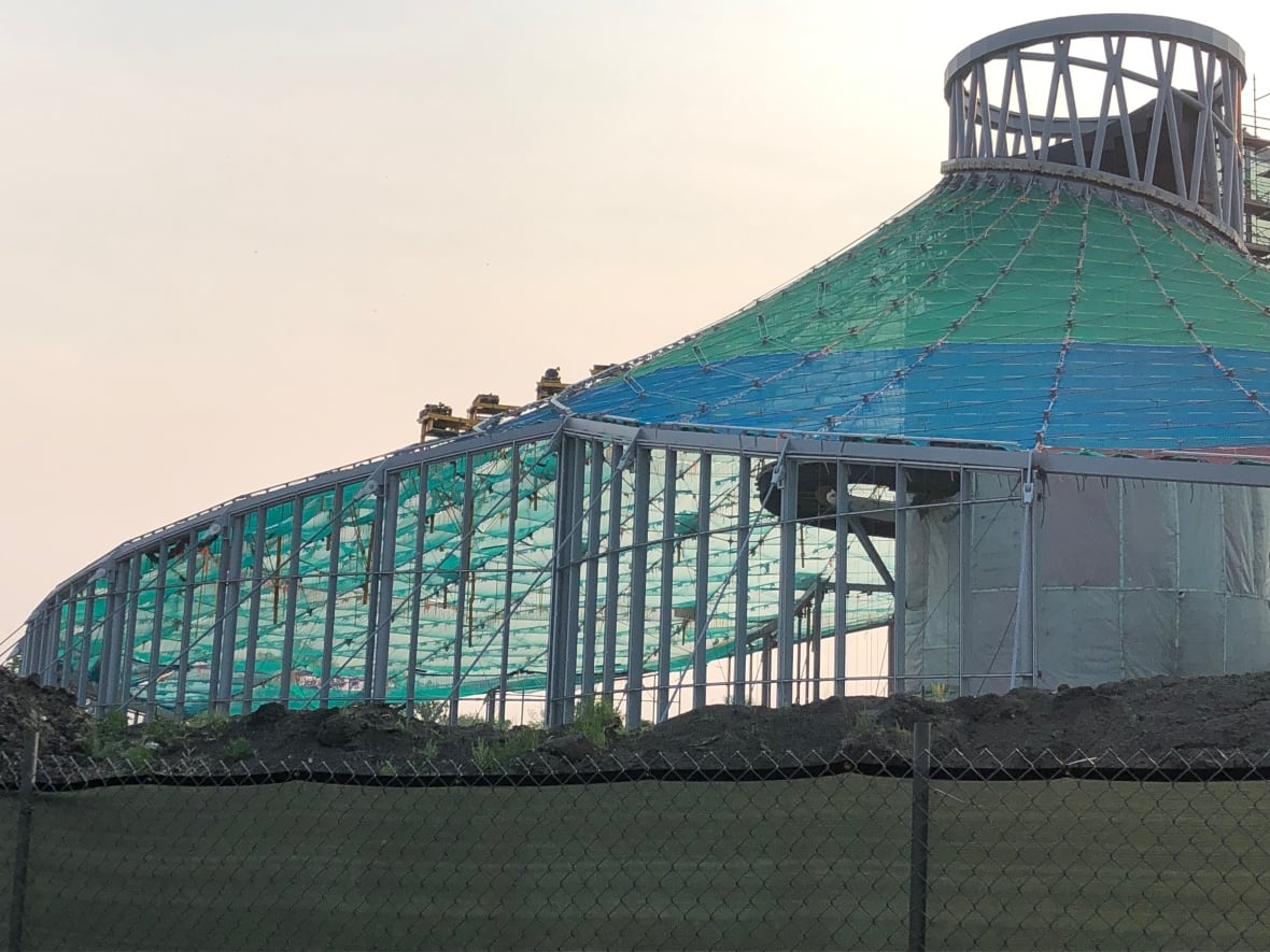 Blue and green coverings on the roof panels of the Leaf building under construction.