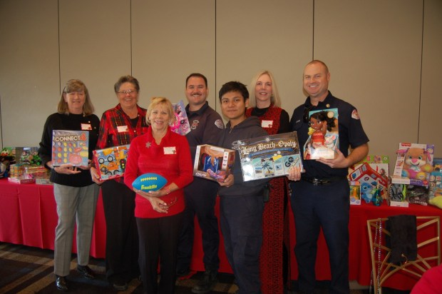 From left, Cheryl Knight, Deanna Scheffel, Jeralee Shewfelt, Matt Sha, David Cortez, Anne Burke and LBFD Jack Crabtree pose for a photo during South Course Golf Course's annual Spark of Love Toy Drive Luncheon on Dec. 13 at Old Ranch Country Club . (Photo courtesy)