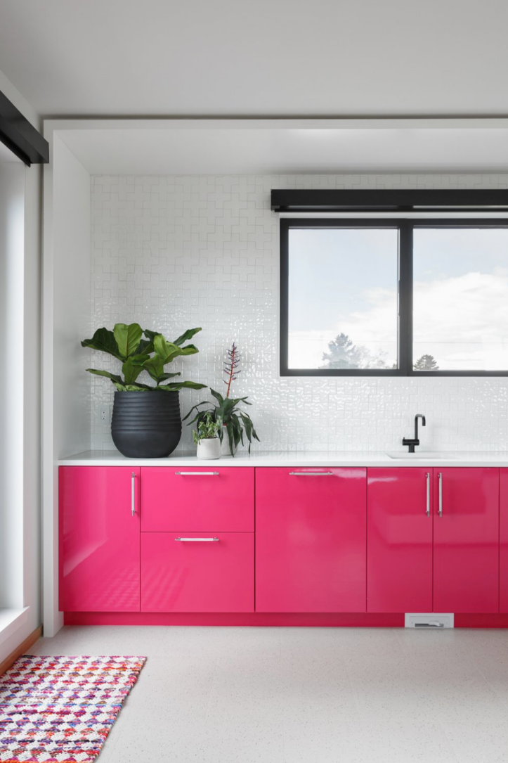 Modern kitchen with light pink furniture and plants