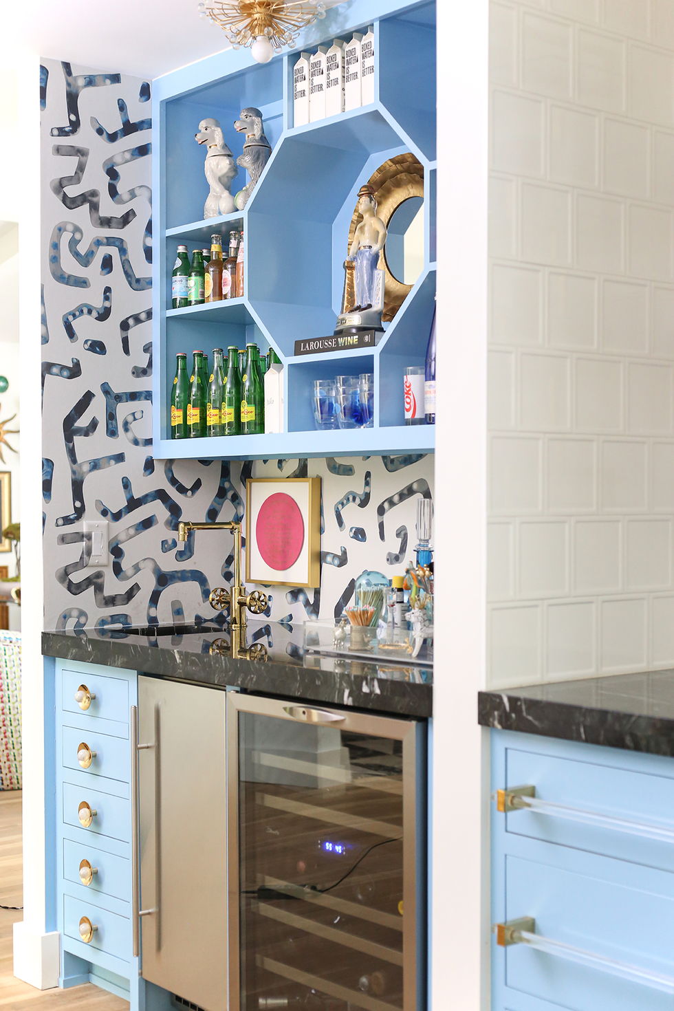 Blue home bar with patterned wallpaper