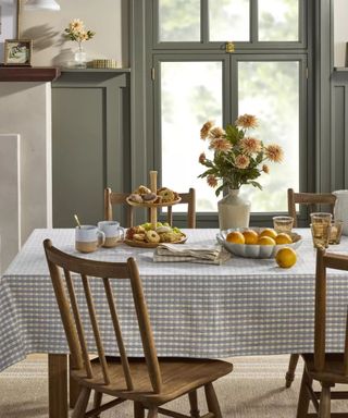 Wooden dining chairs and checkered tablecloth with dinnerware