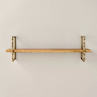 Wall shelf made of turned brass and wood 