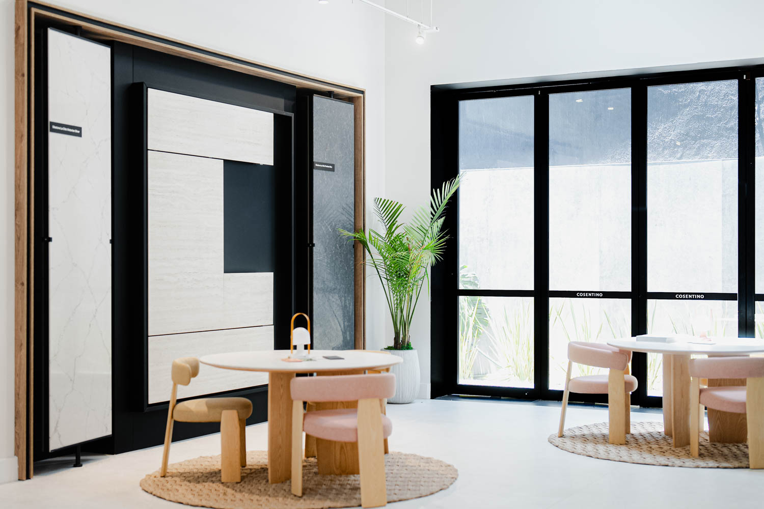 Rooms with black-framed windows and round tables