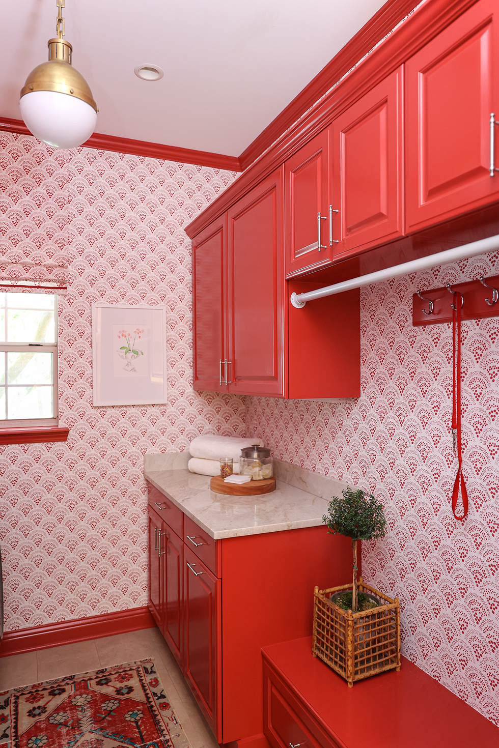 Red laundry room with patterned wallpaper