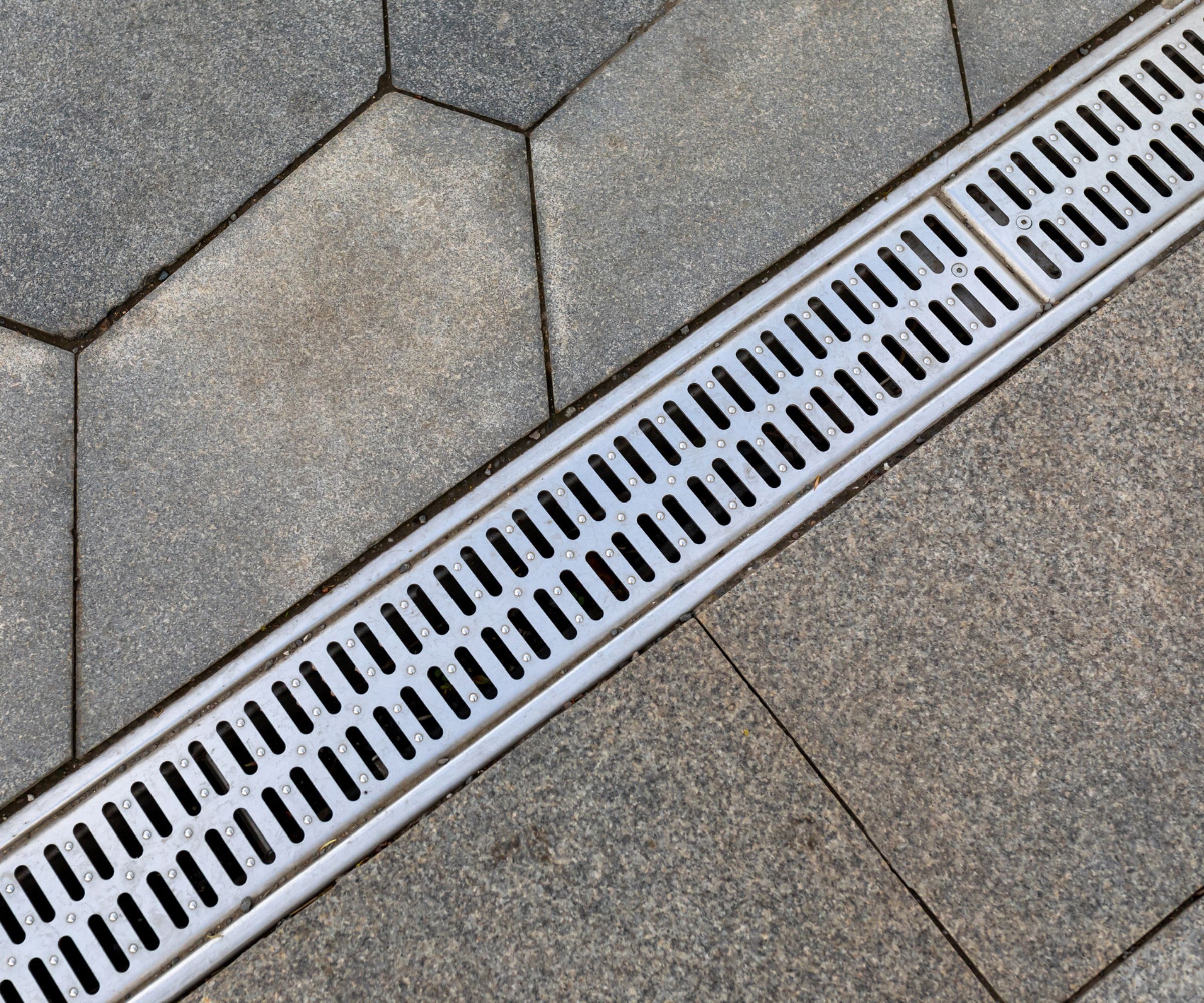 A close-up of a drainage ditch on a patio