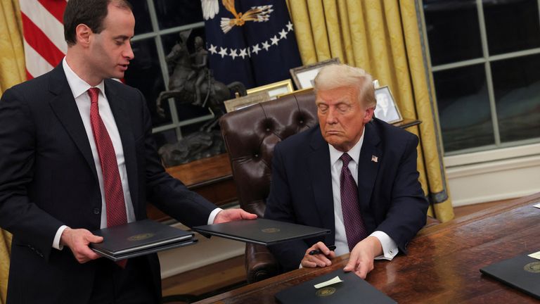 U.S. President Donald Trump signs documents as he issues executive orders and pardons for the January 6 defendants in the Oval Office at the White House on Inauguration Day in Washington, U.S., January 20, 2025. REUTERS/Carlos Barria