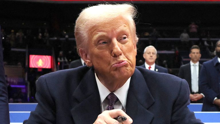 Donald Trump reacts as he signs an executive order during the inaugural parade at Capital One Arena on Inauguration Day of his second term in Washington, United States, January 20, 2025. REUTERS/Carlos Barria