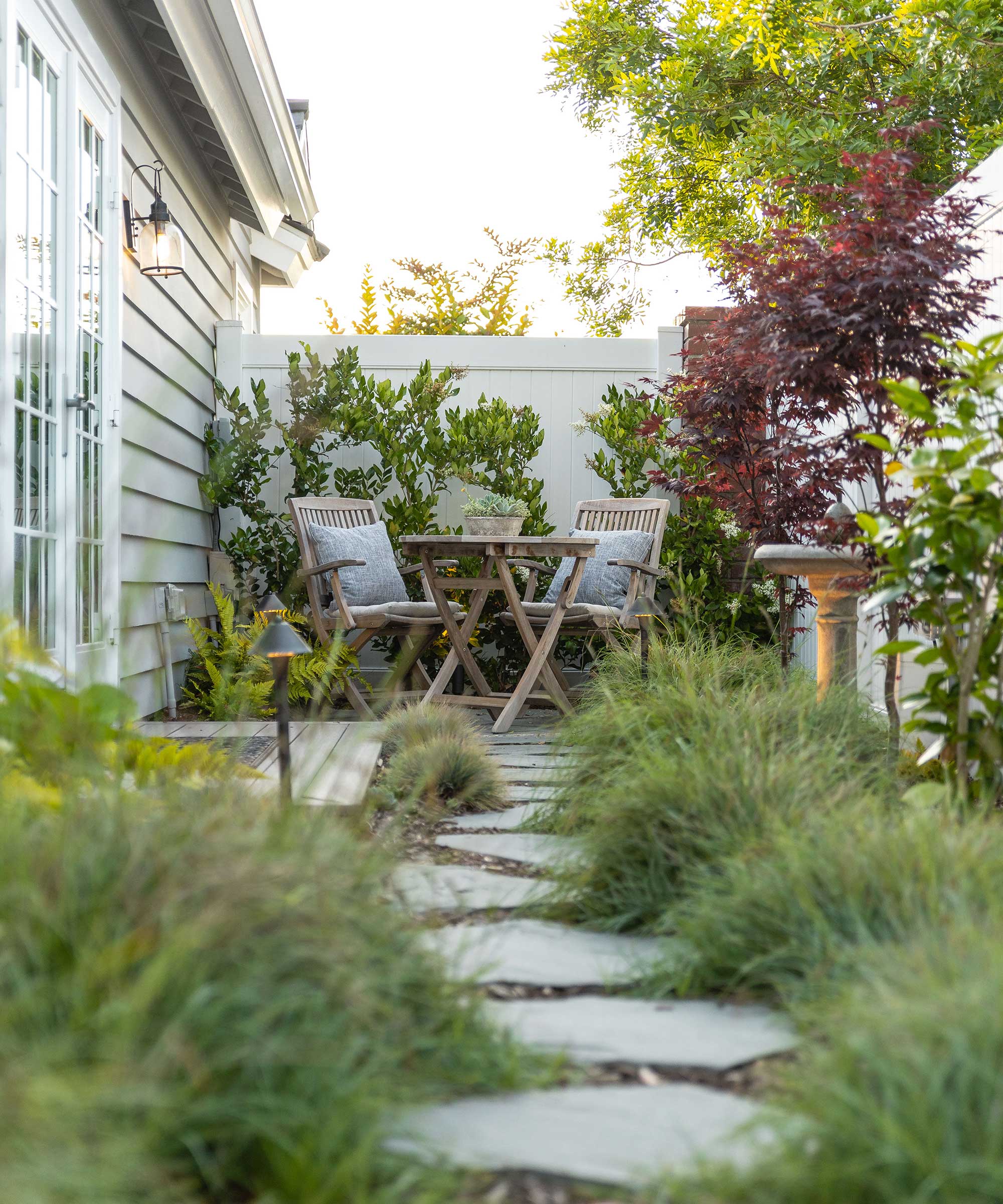 Side courtyard with diving board and seating by Sacha McCrae from Living Gardens Landscape Design