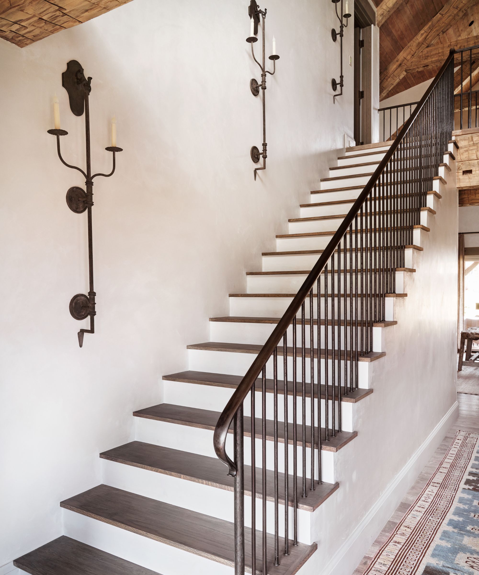 Stairs with rustic iron wall lights