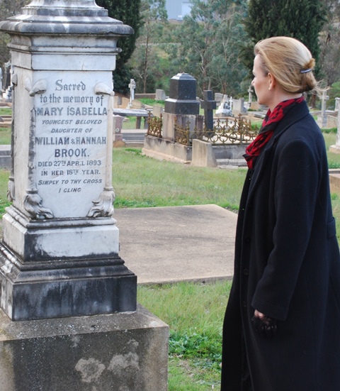 A woman in black in a cemetery