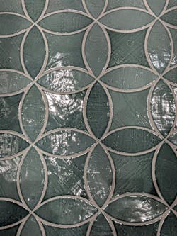 In vibrant, glossy emerald or muted gray-green with purposefully applied depth and shading variation, plenty of tile manufacturers showed a Mediterranean flair. Shown: Cevica’s “Night Fever” club exhibit (large, above) and Natucer Colonial Kite and Petal (inset, left).