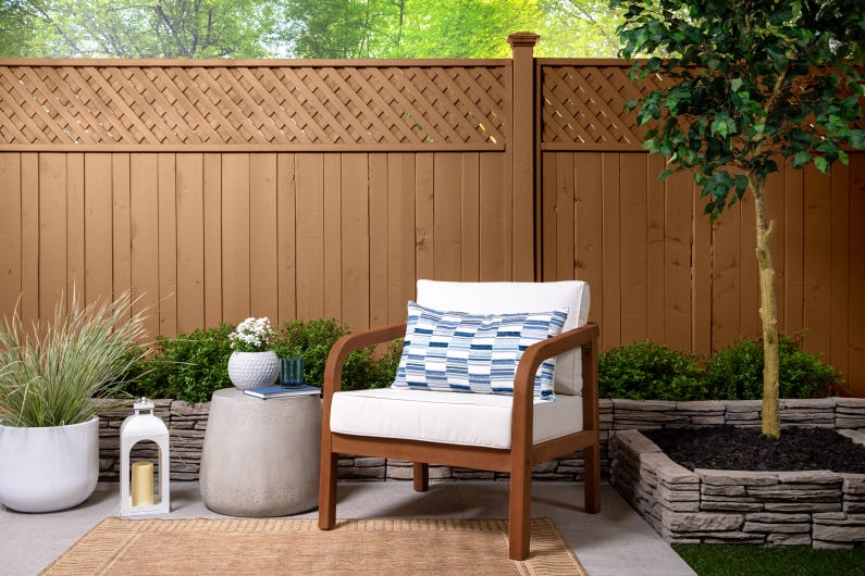 Outdoor seating area with a comfortable chair and decorative elements Outdoor seating area with a comfortable chair and decorative elements