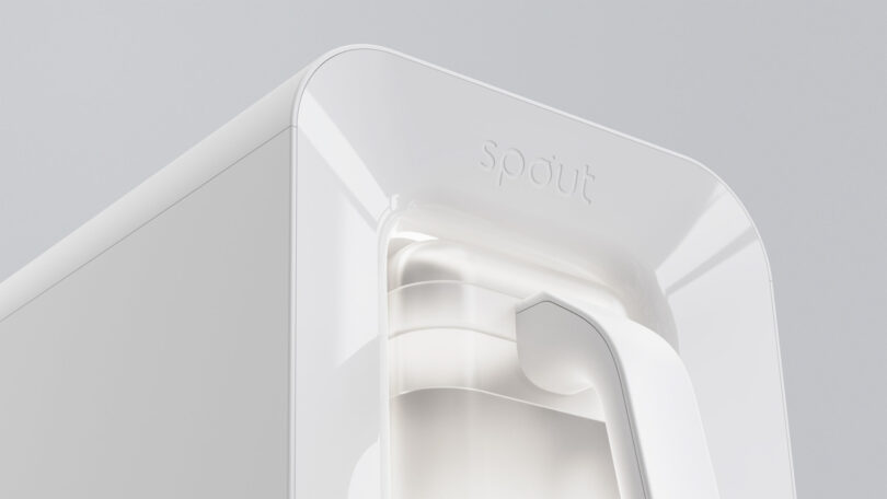 Close up of an elegant white water dispenser with the designation "Spout," Presentation of its minimalist design against a light gray background.