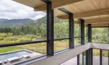 The beautifully manufactured wooden beams and the ceiling seem to fly through the windows of the clerestory. Emphasis on the connection between inside and outside.