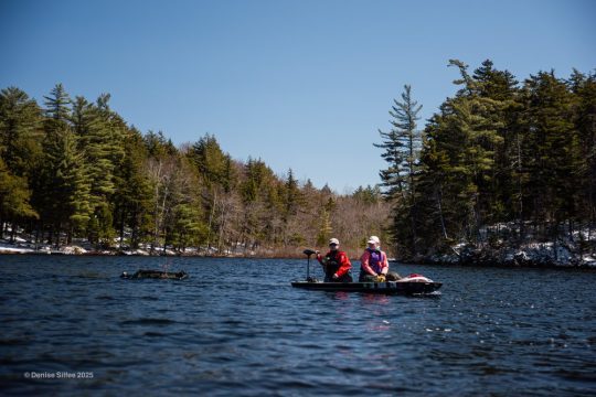Boat driver pull a nest raft across the water
