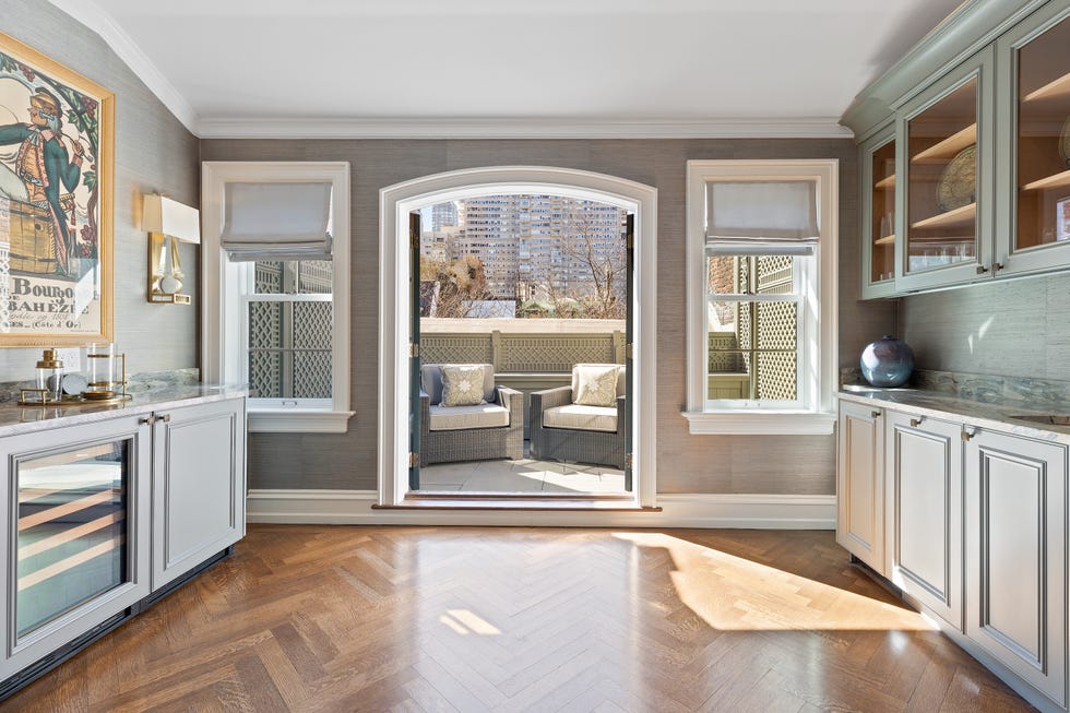 Modern kitchen area with sliding door and access to seating outdoors.