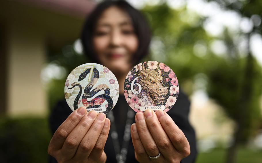 A woman withstands car sticker pull pictures with colorful animal designs.