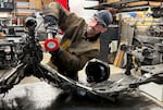 The Metalsmith artist Travis Pond adds part of a metal sculptures operated in the course of the metal sculpture. The finished product will resemble a heron in flight.