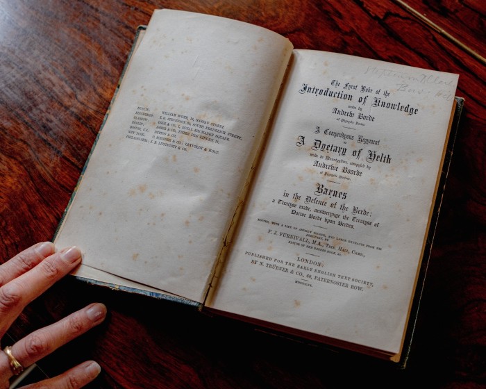 Old book was opened on a wooden table