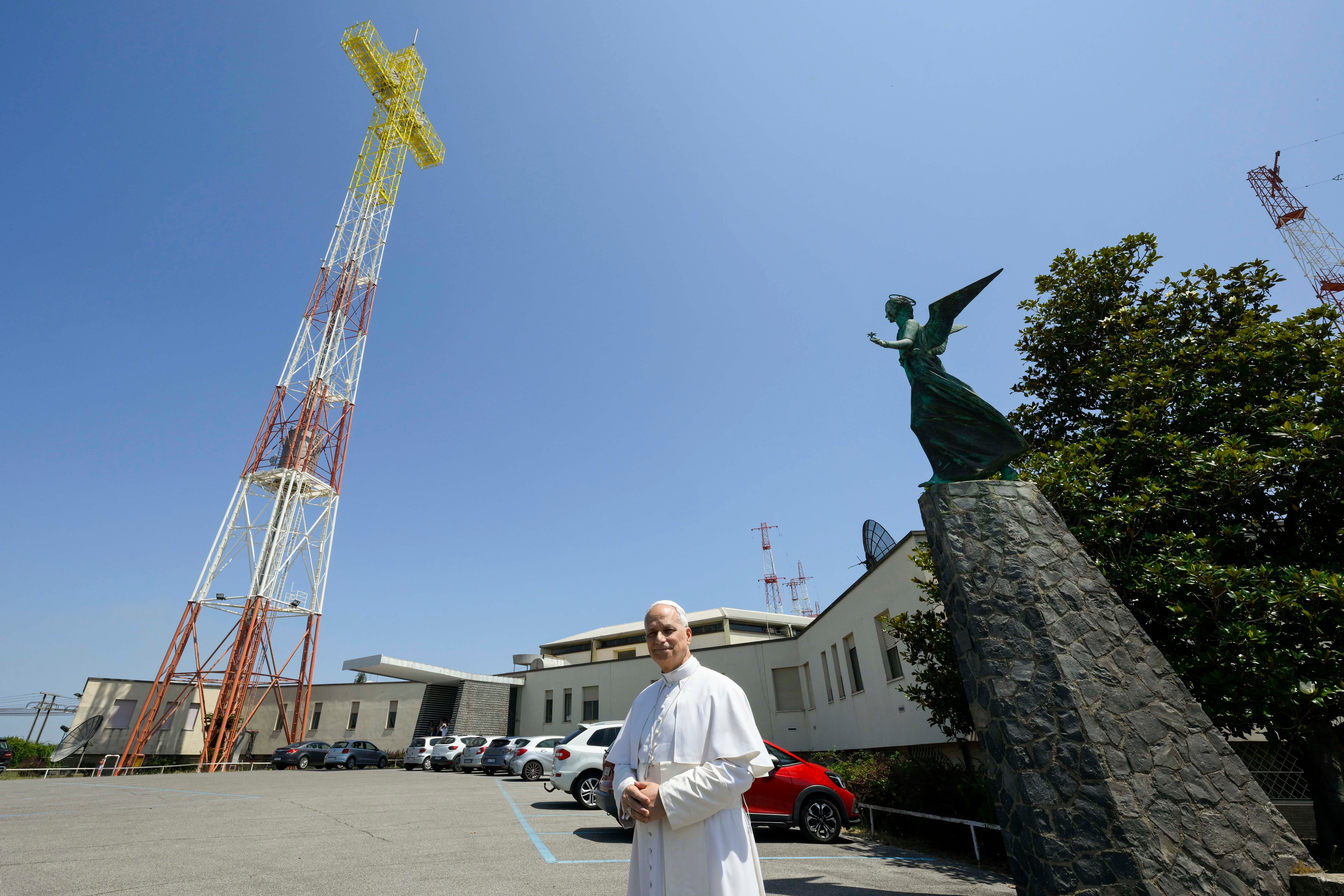 Pope Leo stands in front of the Vatican radio transmission center