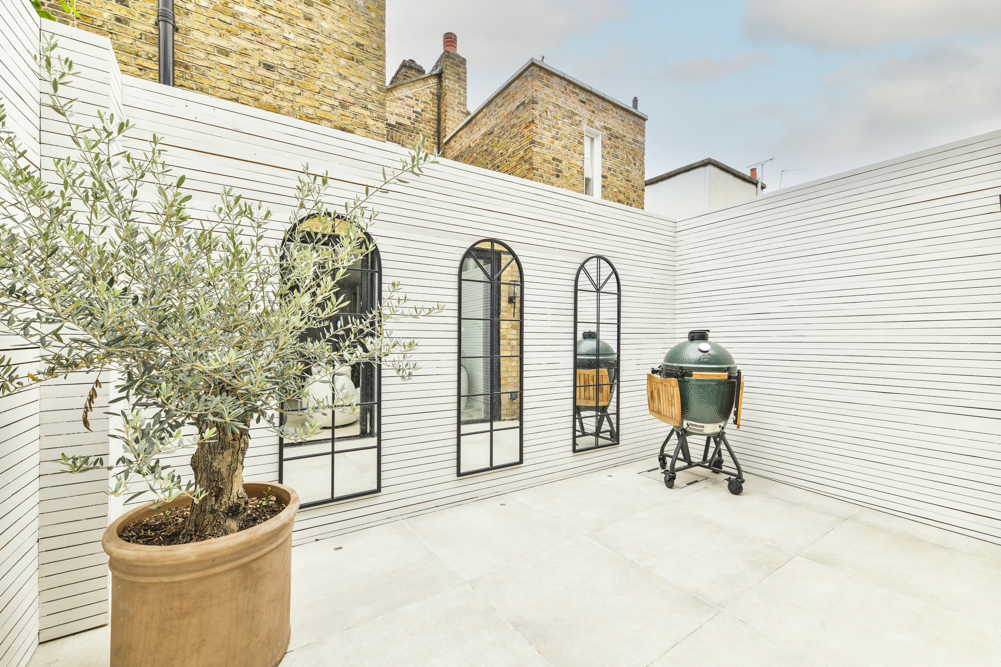 In the inner courtyard garden with excessive vaulted mirrors and Olive Tree from Project London