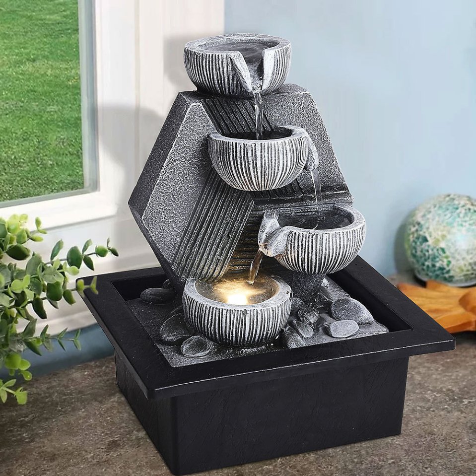 Table surface fountain with four steps.