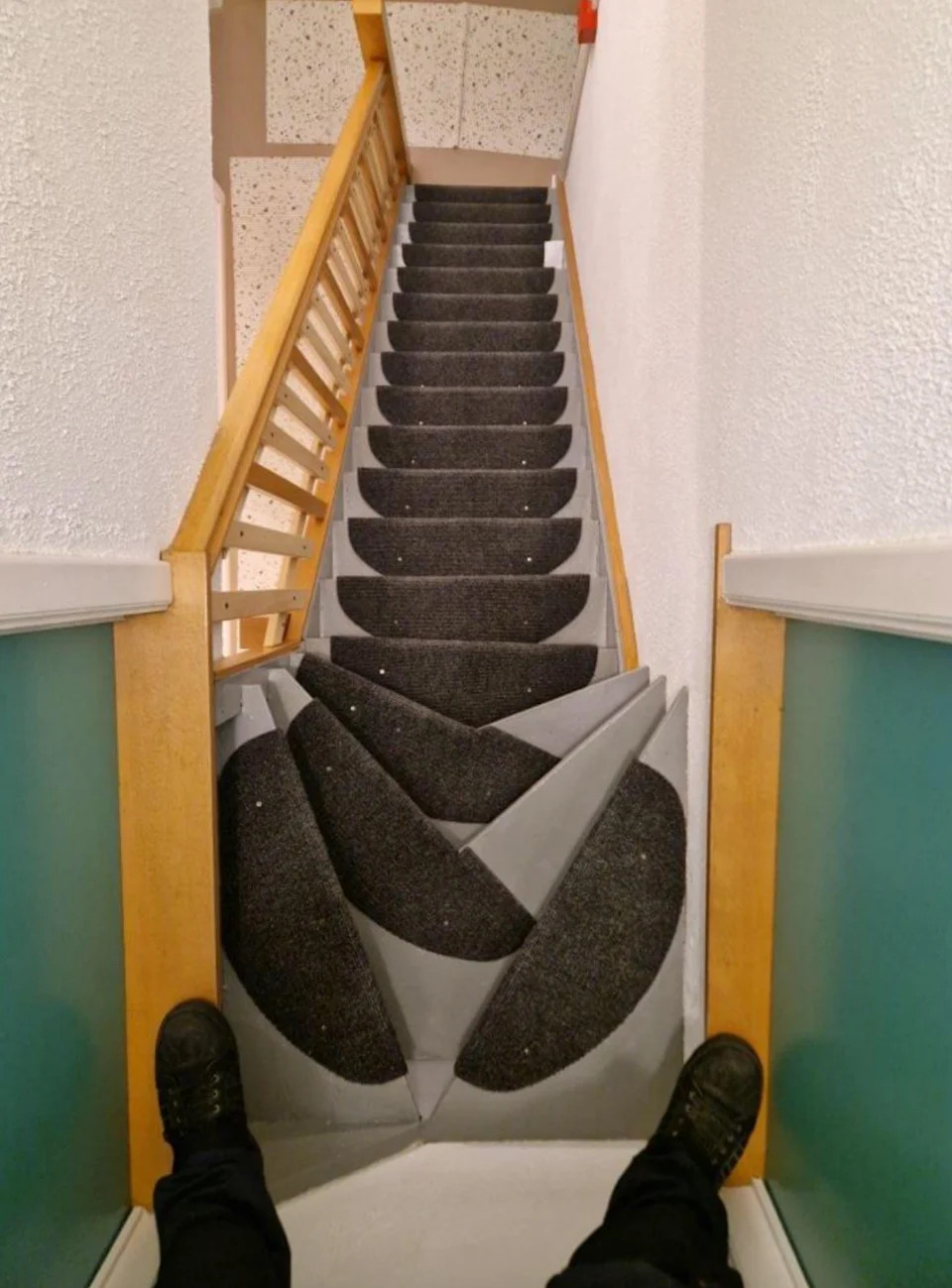 Stairs with overlapping carpet patterns and create an optical illusion. Viewable view from above with shoes above