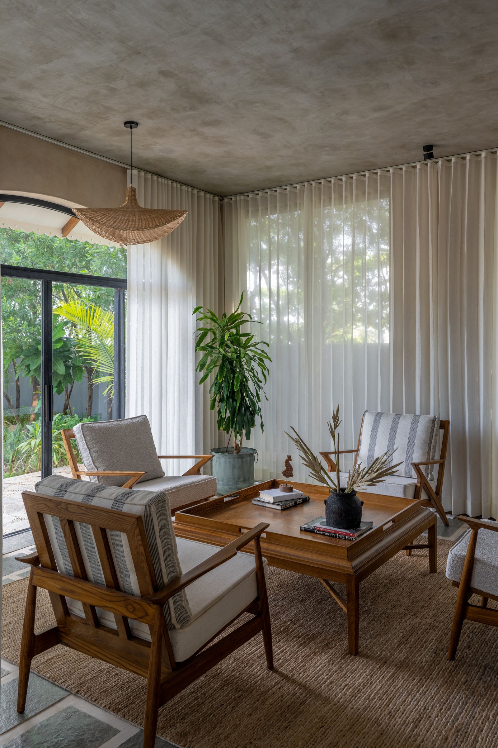 Image can contain plant -based coffee table furniture table lamp lamp in the interior design chair and book