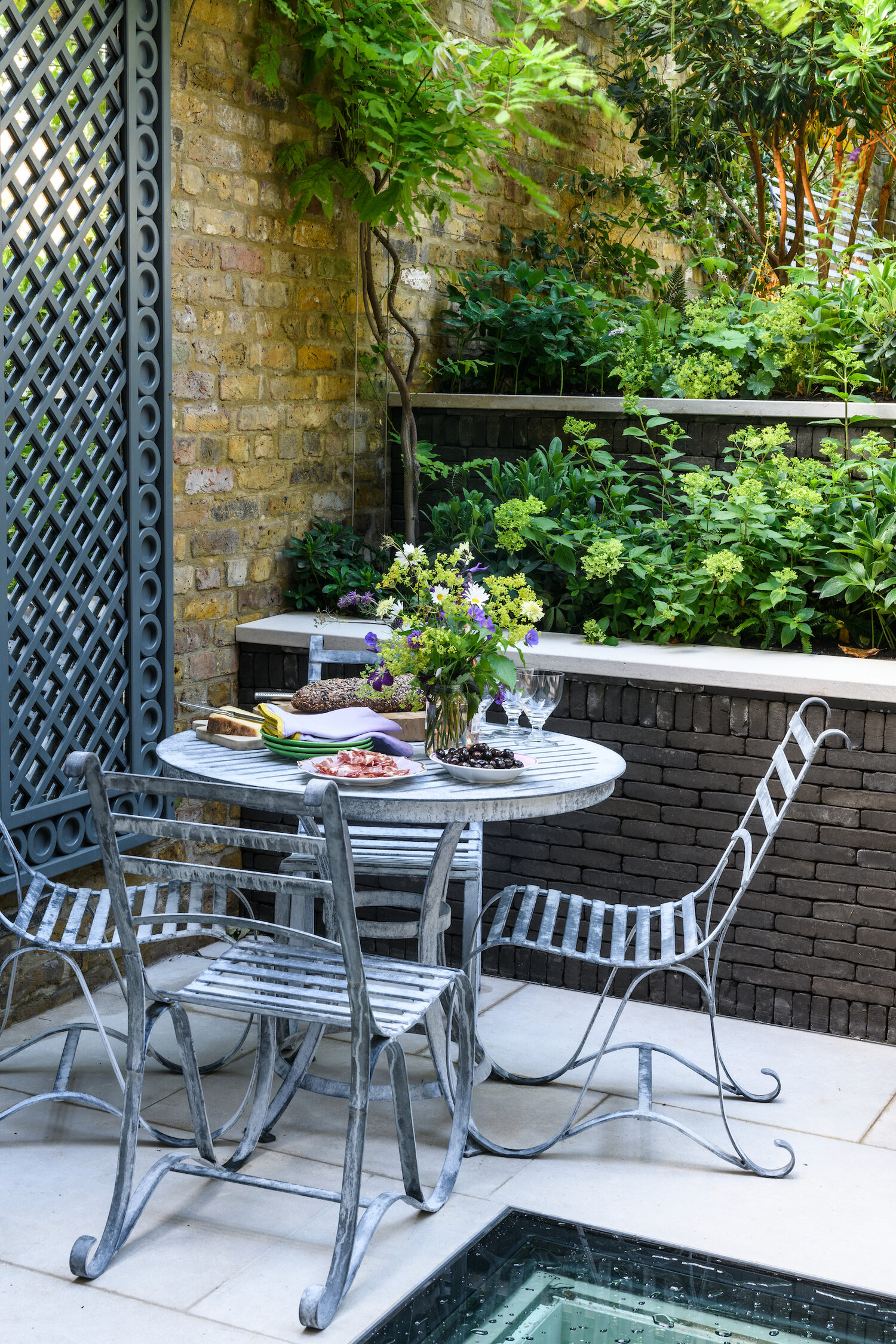 Garden mirror in the courtyard next to table outdoors