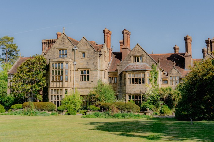 An Elisabethan Villa house with a lawn.