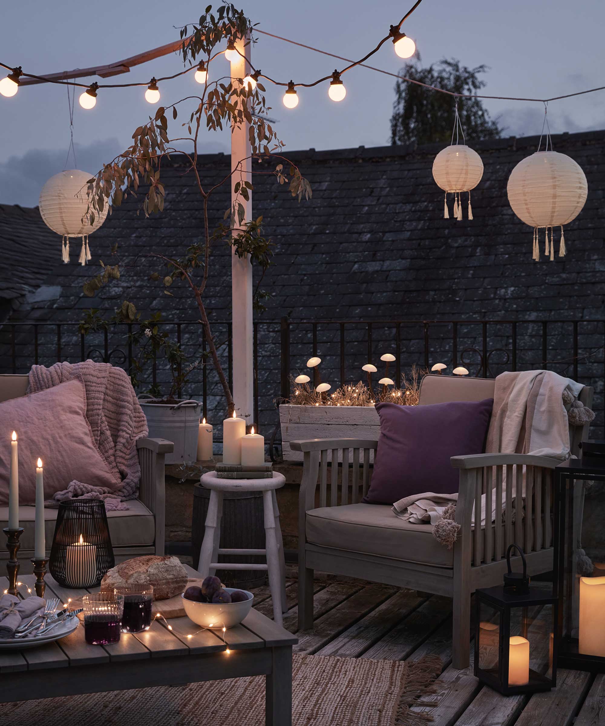 Seating outdoors with layered lighting by Lights4fun