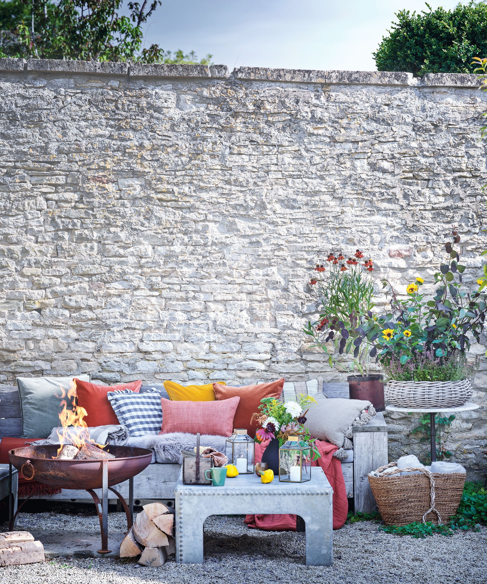 Rustic seating area with red and orange pillows
