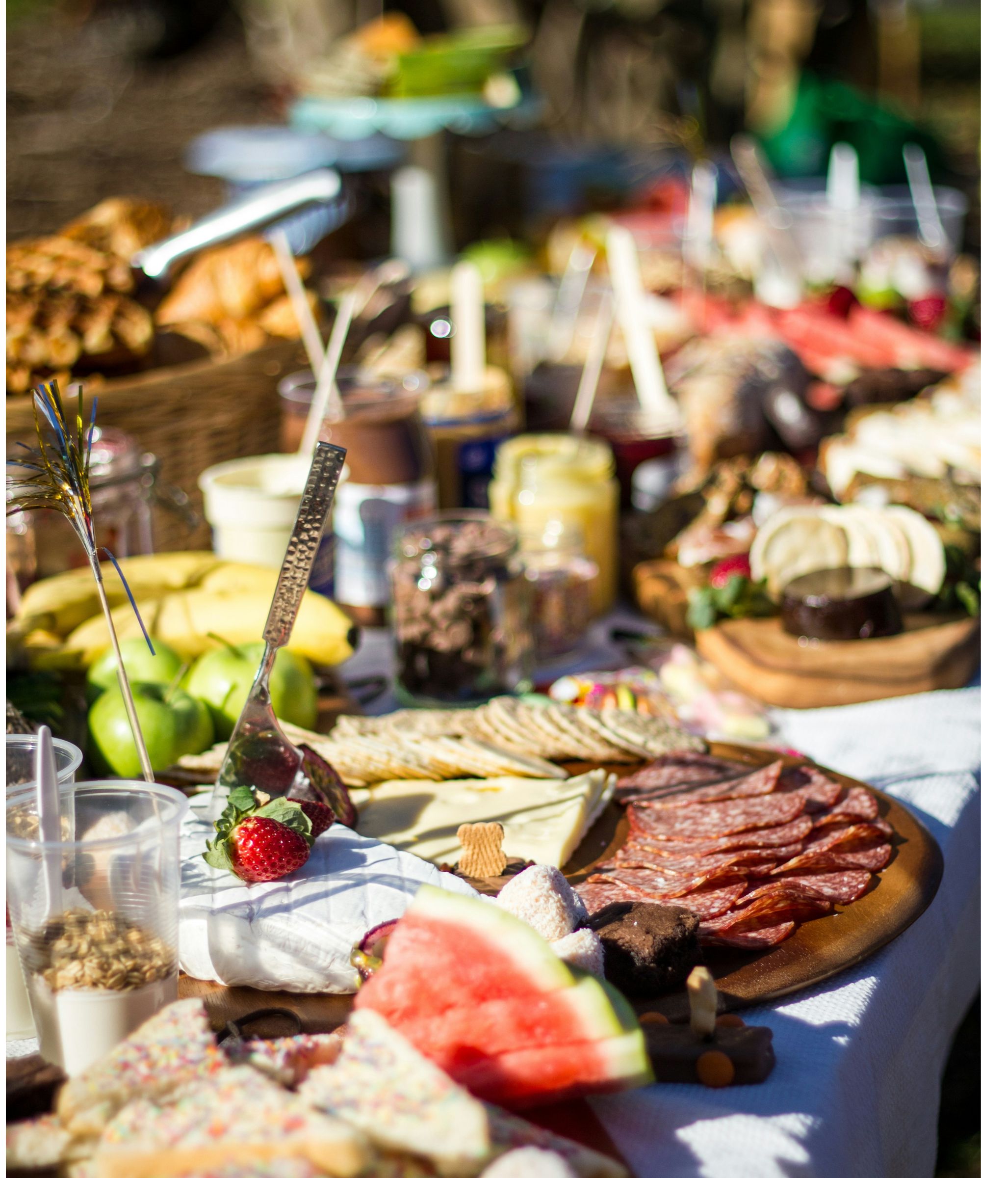Table of summer starters such as meat, cheese, olives and watermelon