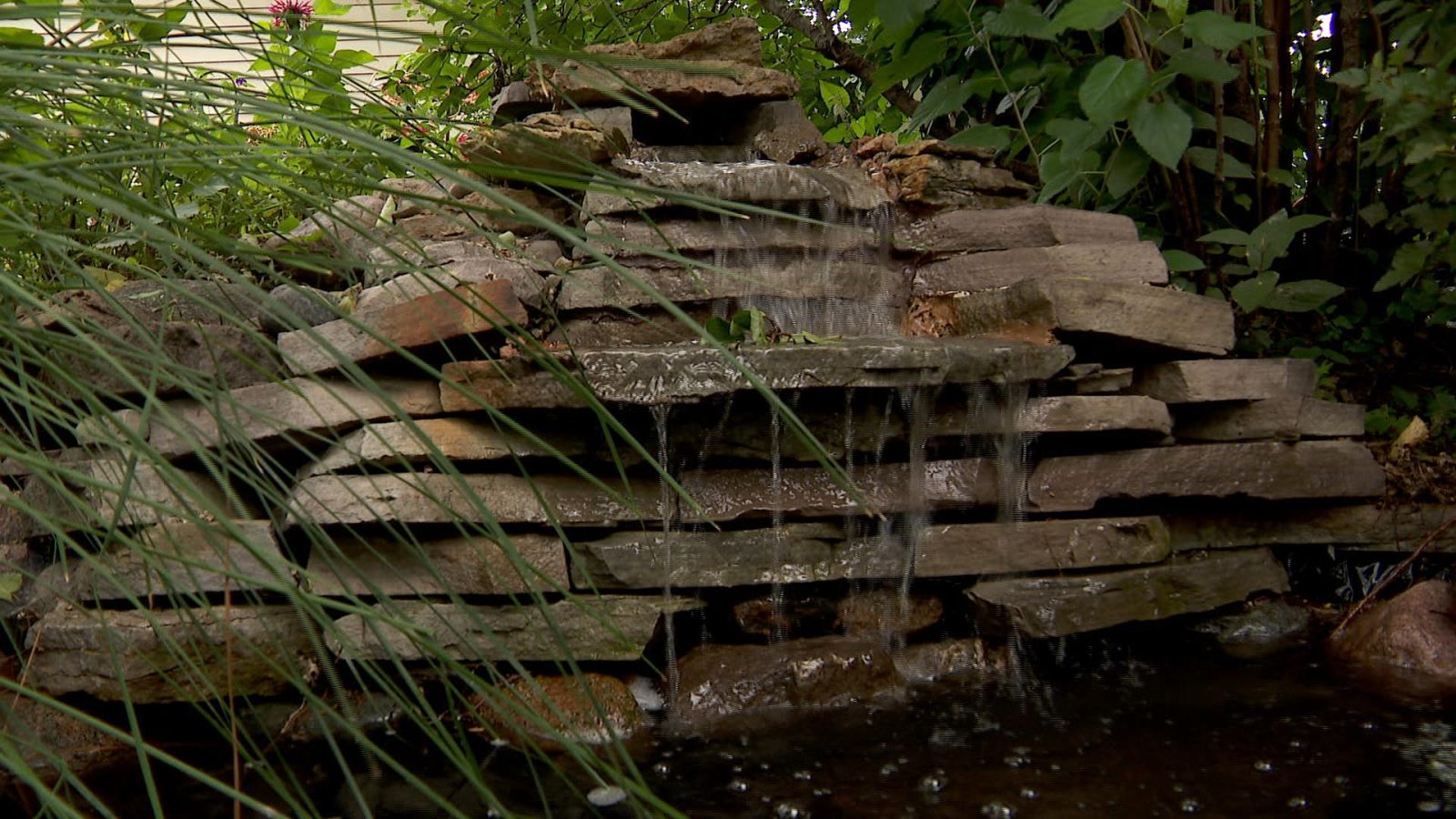Homemade water falls into a garden in crystal.