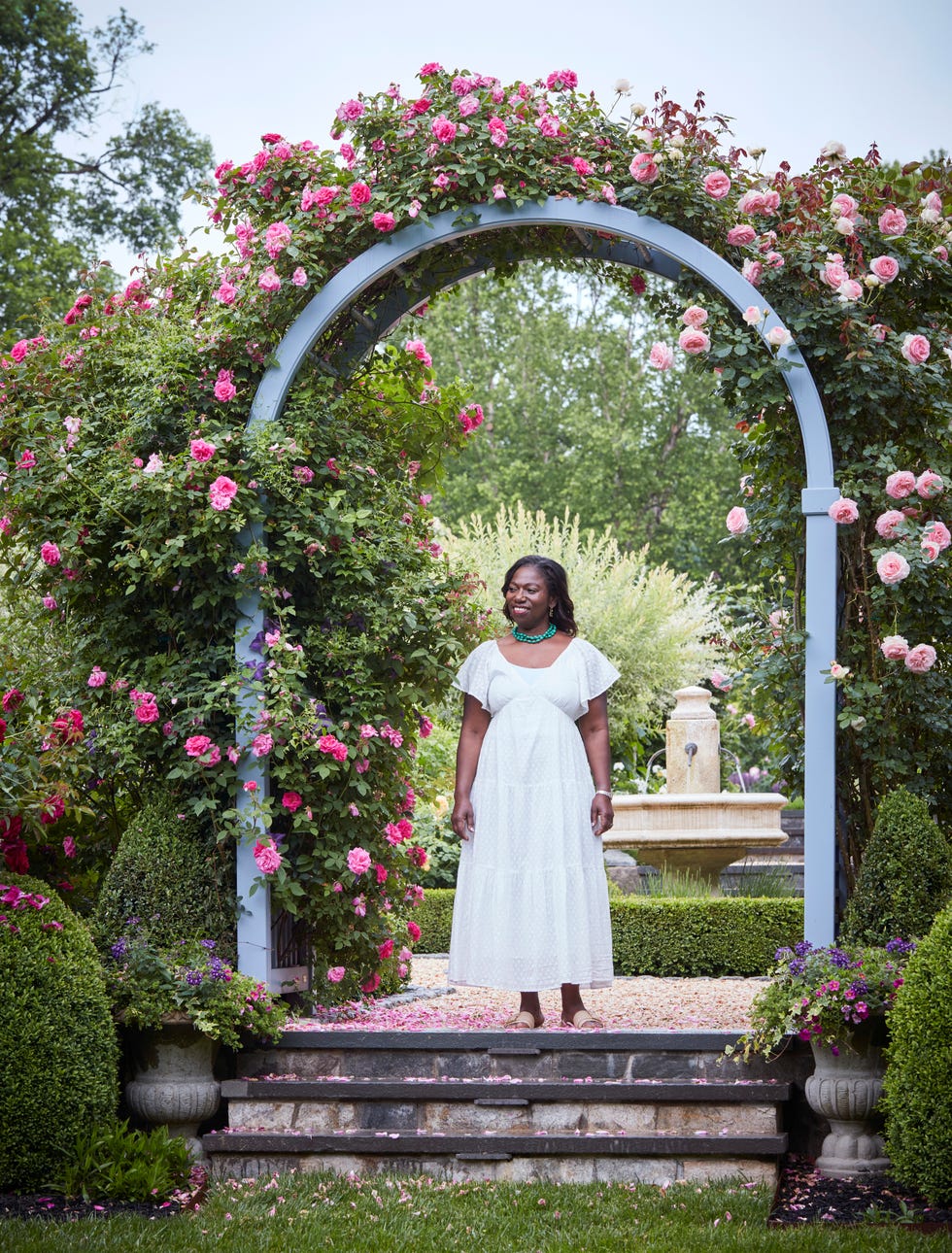 Yvonne Tsikata is located under a romantic arcade in fragrant zéphirine Drouhin- and Eden climbing roses.