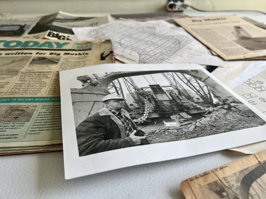 In his house in McConnelsville, a black and white photo by Eddie Lindimore is created in front of Big Muskie.