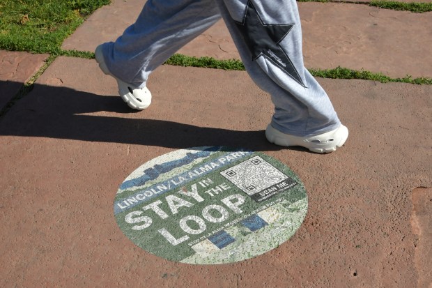 Stay on the sidewalk in La Alma Lincoln Park in Denver in the Loop sign. (Photo by Hyoung Chang/The Denver Post)