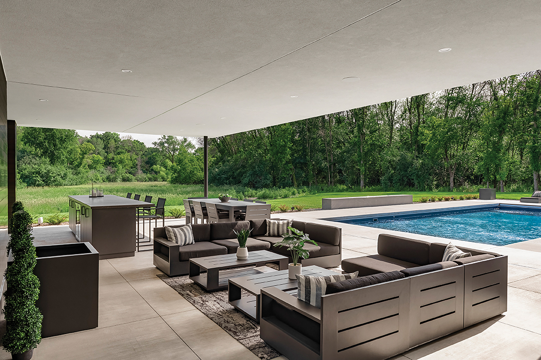 Outdoor kitchen and pool area of Orono Home