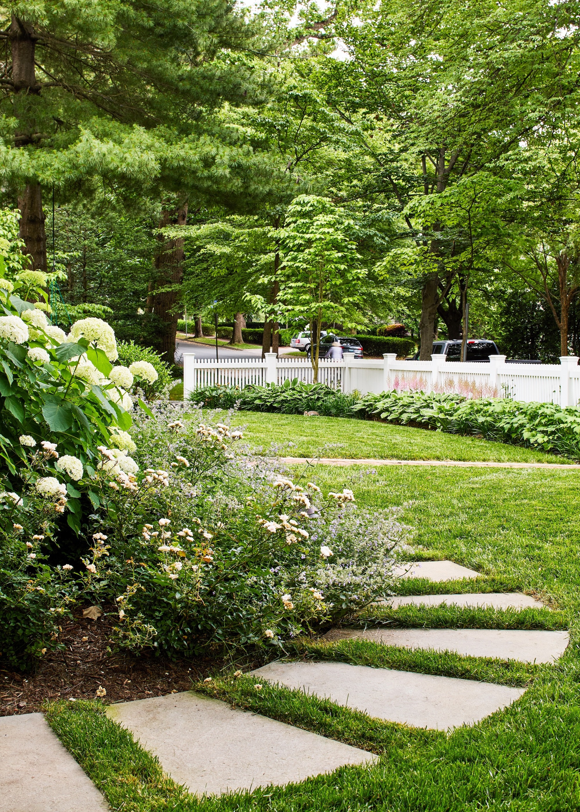 Garden path with structured spacer plates next to a flower bed