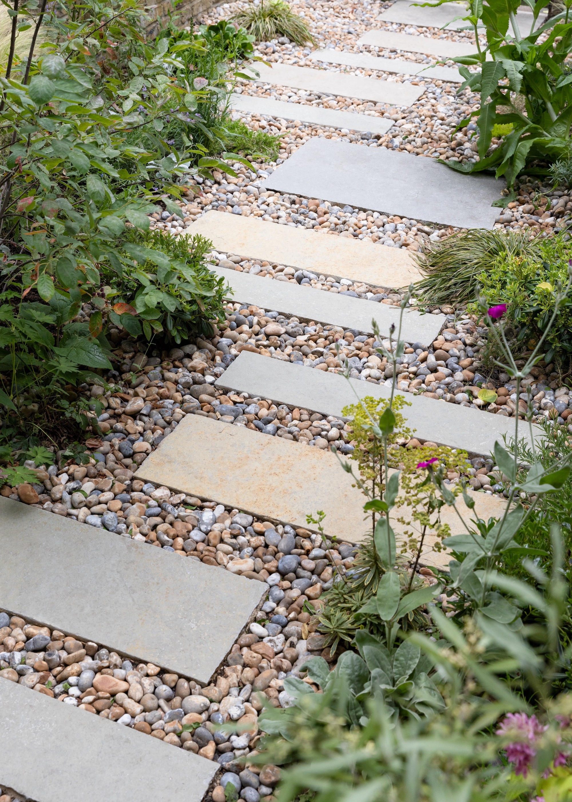 Garden path made of staggered slabs and pebbles