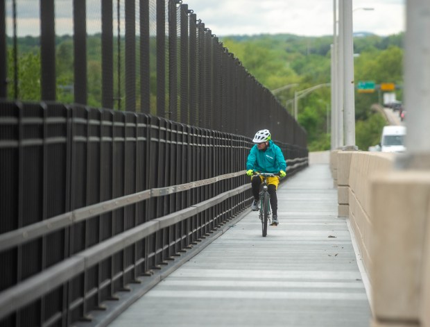 The cyclist Gary Kleeblatt from Wethersfield rides his bike along the recently opened Putnam Bridge Trail, which connects Wethersfield with Glastonbury via the Connecticut River. The attempt is part of the South Meadow Greenway. (Aaron Flaum/Hartford Courant)