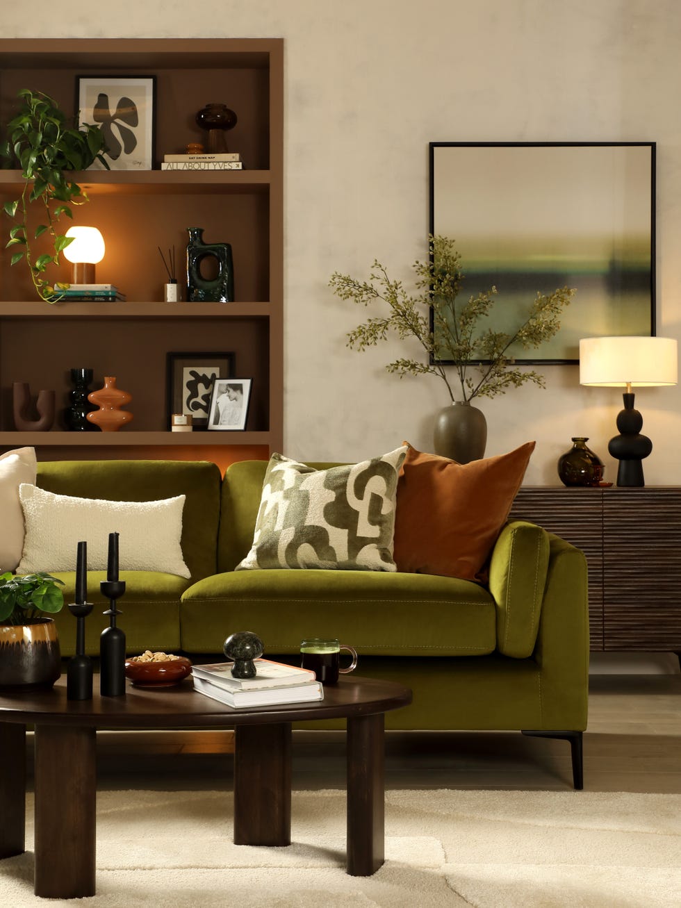 Mushroom Core Living Room a living room with a green sofa, a dark brown wooden table and a shelf behind it