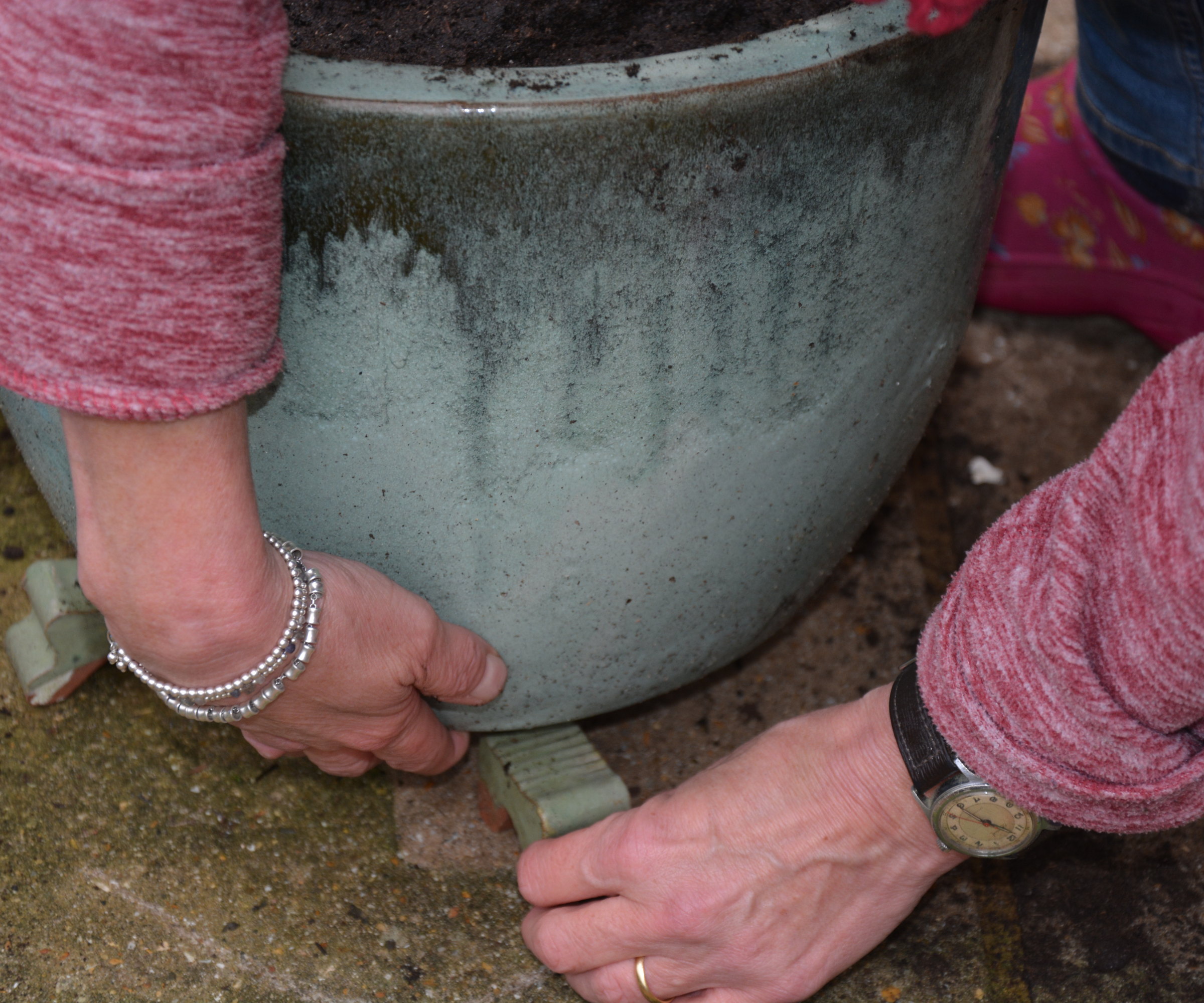 Place feet under pots to raise them off the ground