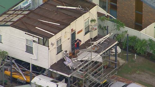 Storms in southeast Queensland are ripping off roofs, dropping huge hail and leaving 95,000 people without power