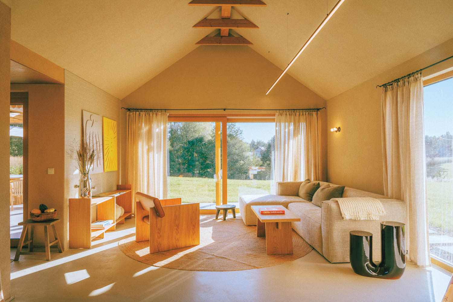 Living area with white couch and sun-filled light