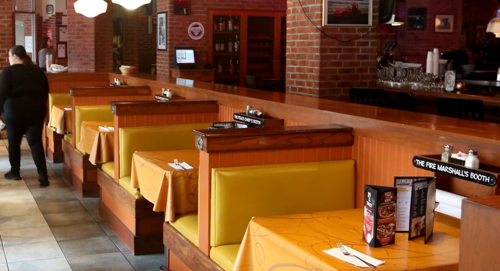 A photo of the Uno Chicago Bar & Grill in downtown Dayton taken in the late 2010s. The restaurant closed in 2024. At some stands, nicknames were printed on signs on wall-mounted paper towel holders. A former Dayton police lieutenant was under investigation for removing and taking three signs in May 2025. EMPLOYEES