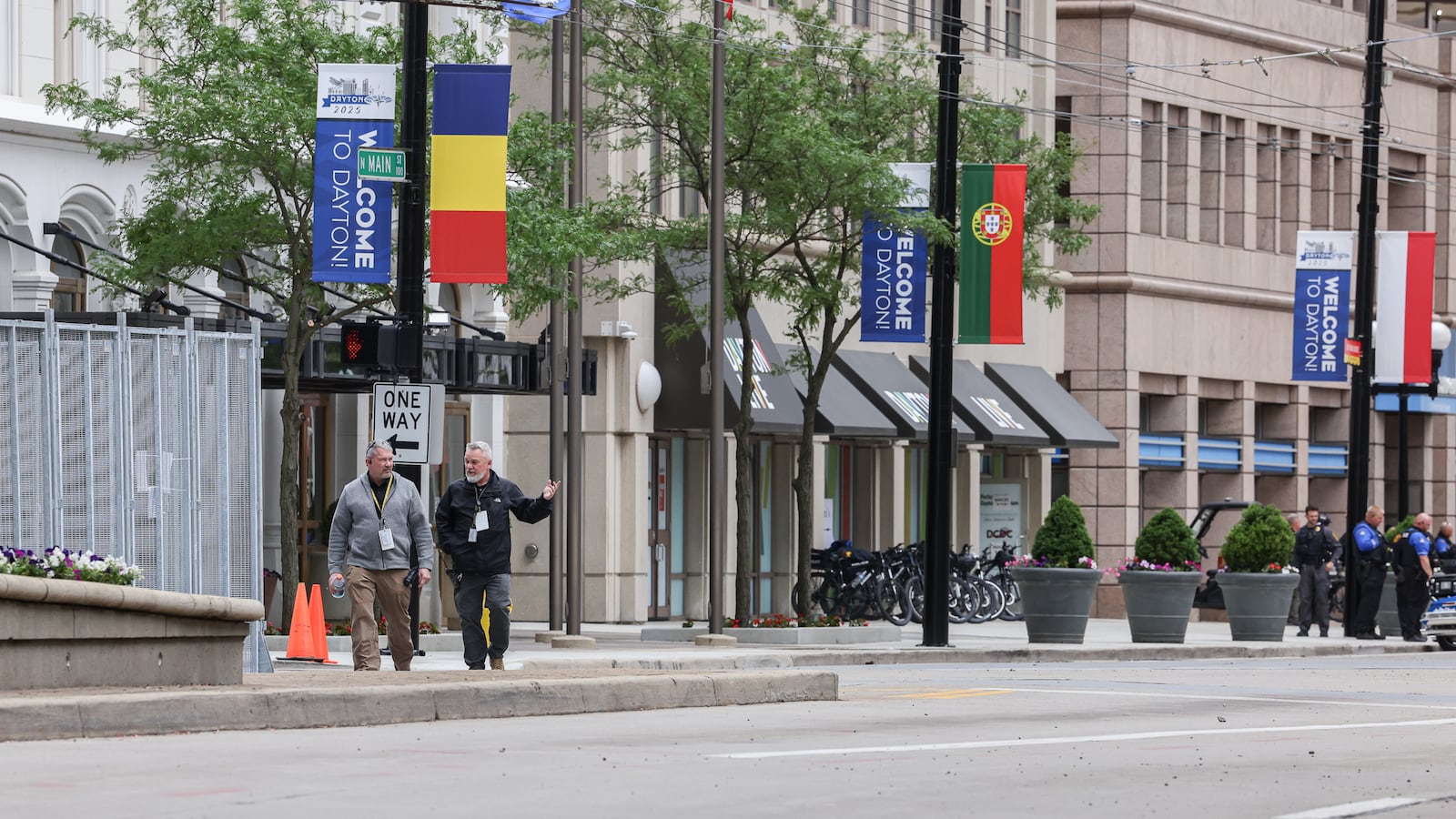 On May 22, 2025, two men walk along North Main Street in downtown Dayton in a security zone set up for the NATO Parliamentary Assembly. A Dayton Live property that was formerly Uno Chicago Bar & Grill can be seen in the background. The former restaurant was used as a break area for police during the event. BRYANT BILLING / STAFF