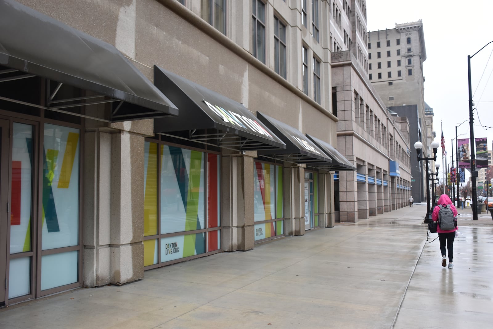 A woman walks past the former Uno Chicago Bar & Grill at 126 N. Main St. in downtown Dayton, which closed in 2024. The open space was used as a law enforcement breakout area during the NATO Parliamentary Assembly held in Dayton over Memorial Day weekend. CORNELIUS FROLIK / EMPLOYEES