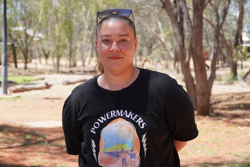 A woman with sunglasses on her head looks into the camera.